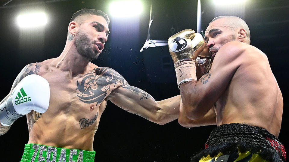 Pictured here, Anthony Mundine gets set to cop a punch from Michael Zerafa in their boxing bout.