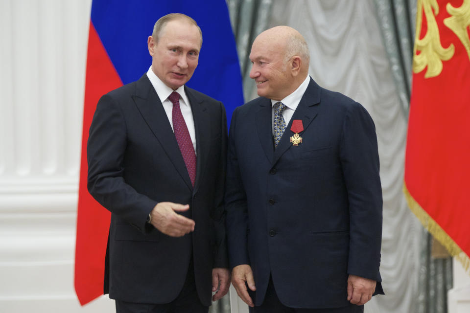 FILE - In this Thursday, Sept. 22, 2016 file photo, Russian President Vladimir Putin, left, presents a medal to former Moscow Mayor Yuri Luzhkov during an award ceremony in Moscow's Kremlin, Russia. The former mayor of Moscow and one of the founders of Russia's ruling United Russia party, Yuri Luzhkov, has died at the age of 83. Russia's Ren TV channel reported Tuesday Dec. 10, 2019, that Luzhkov died in Munich, where he was undergoing heart surgery. (AP Photo/Ivan Sekretarev, pool, FIle)