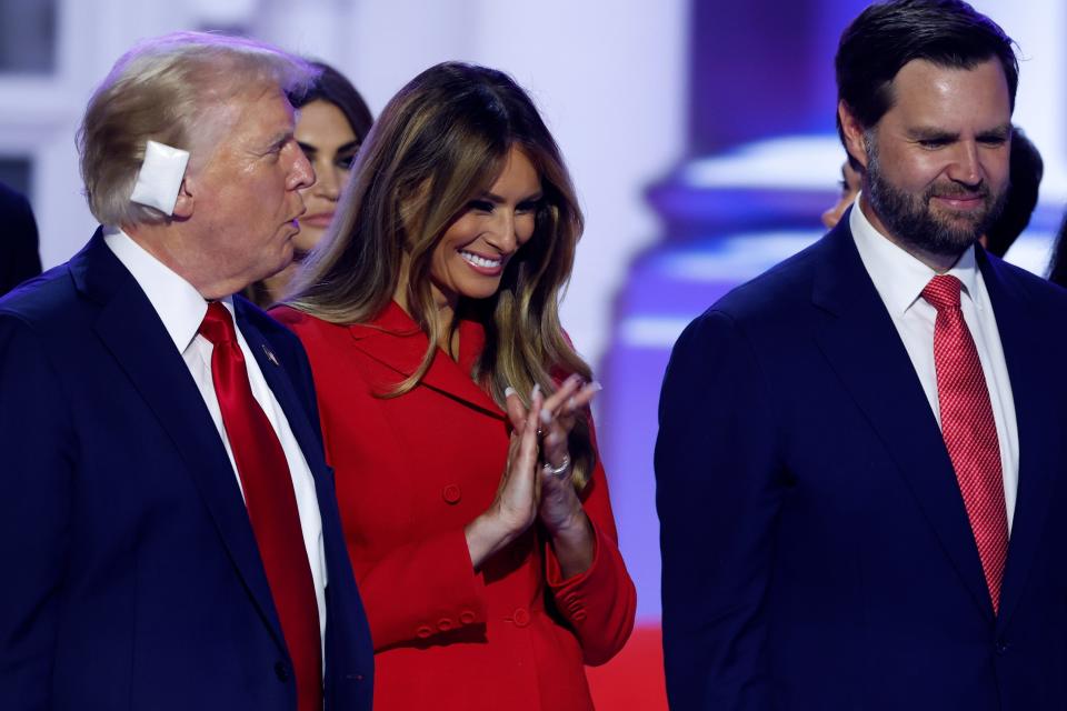 Former President Donald Trump, who dodged an assassination attempt on July 13, 2024, celebrates after accepting the Republican presidential nomination five days later in Milwaukee with former first lady Melania Trump and Republican vice presidential nominee JD Vance.