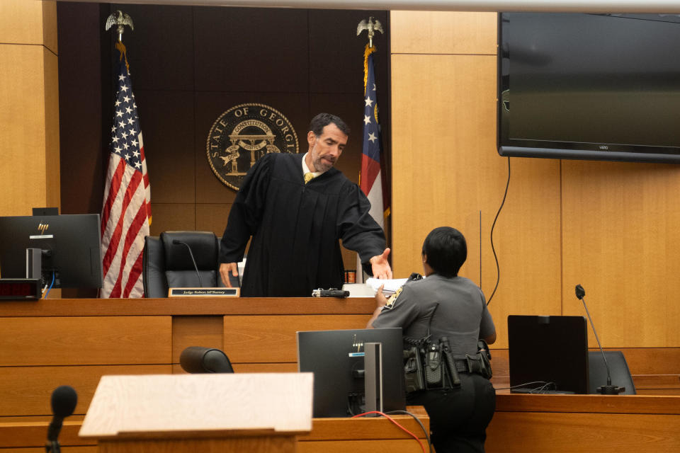 Fulton County Superior Court Judge Robert McBurney receives court documents on Aug. 14, 2023 in Atlanta, Georgia. A grand jury delivered an indictment against former President Donald Trump and 18 others on charges including racketeering related to alleged efforts to overturn the 2020 election. / Credit: Megan Varner / Getty Images