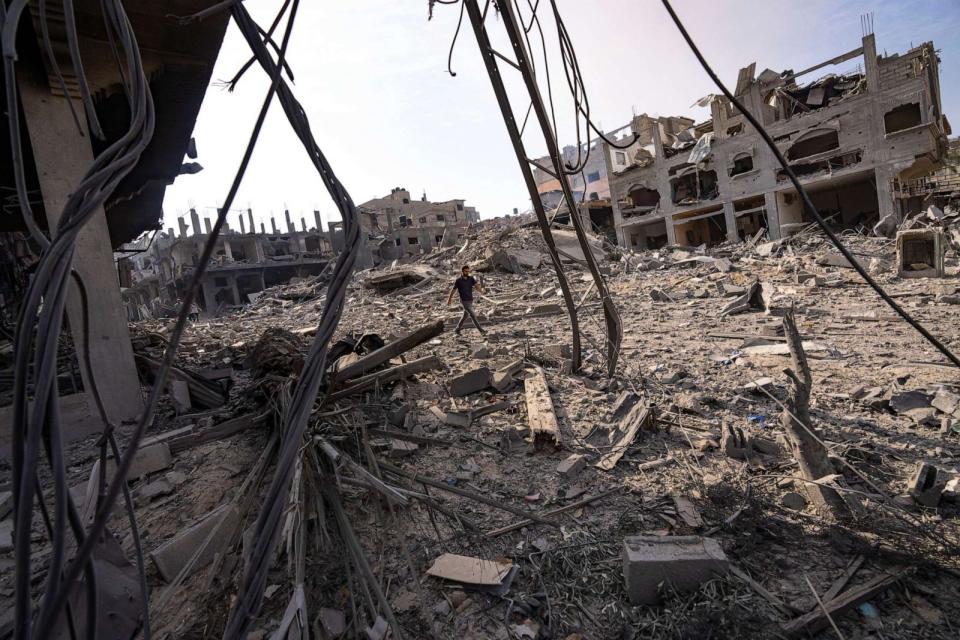 PHOTO: A person walks through the destruction by Israeli bombing in Gaza City, Oct. 11, 2023. (Fatima Shbair/AP)