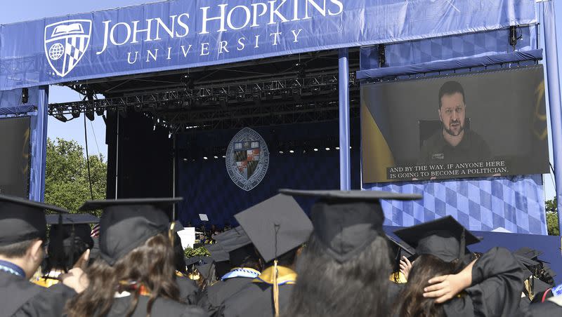 In this handout photo released by Johns Hopkins University, Ukrainian President Volodymyr Zelenskyy addresses the graduating class of Johns Hopkins University via livestream from Ukraine, Thursday, May 25, 2023, in Baltimore, Md.