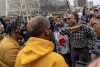 Trump supporter C.L. Bryant, right, argues with counter protestors Angelo Austin, left, and Ralph Gaines, center, while Trump supporters demonstrate against the election results outside the central counting board at the tcf Center in Detroit, Thursday, Nov. 5, 2020. (AP Photo/David Goldman)