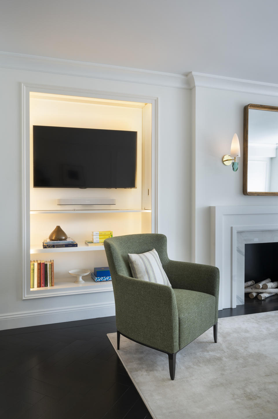 living room with bookcase that slides open to reveal hidden TV