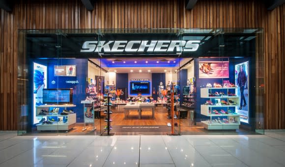 Skechers storefront with blue neon lights in the window displays