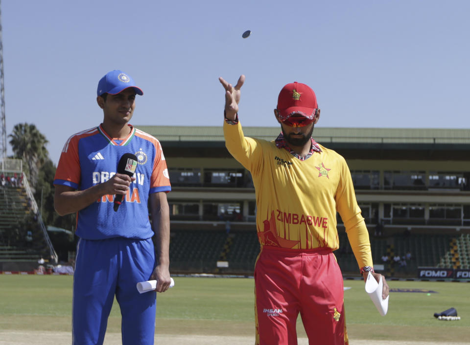 Zimbabwe's cricket captain Sikandar Raza tosses the coin while India's Shubman Gill, left, looks on at the Harare Sports Club, Wednesday, July 10' 2024 prior to the start of their third T20 match. (AP Photo/Wonder Mashura)