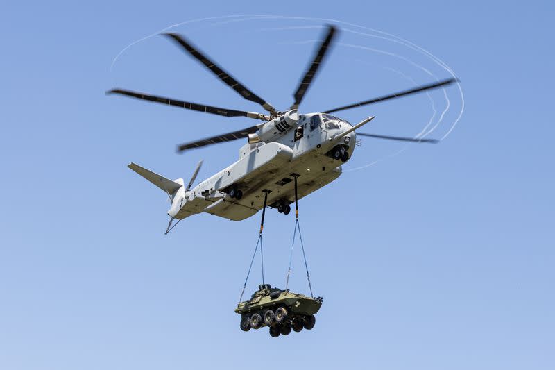 Marines with Marine Operational Test and Evaluation Squadron 1 transport a Light Armored Vehicle 25 with a CH-53K King Stallion helicopter over Camp Lejeune, North Carolina, in April. (Lance Cpl. Elias E. Pimentel III/Marine Corps)<cite class="op-small">Lance Cpl. Elias Pimentel</cite>