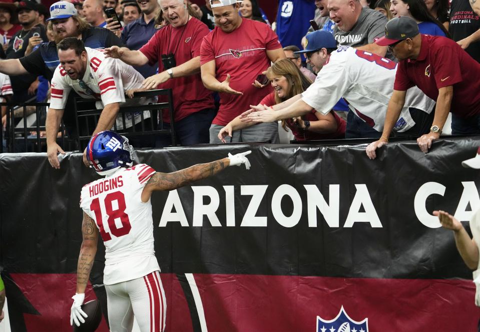 New York Giants wide receiver Isaiah Hodgins (18) greets the Giants fans after making a touchdown catch against the Arizona Cardinals in the fourth quarter at State Farm Stadium in Glendale on Sept. 17, 2023.