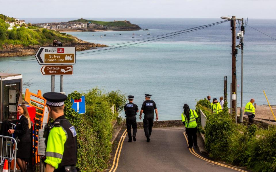 Police and security teams keep a heavy presence in Carbis Bay, Cornwall, ahead of the G7 summit. - SWNS