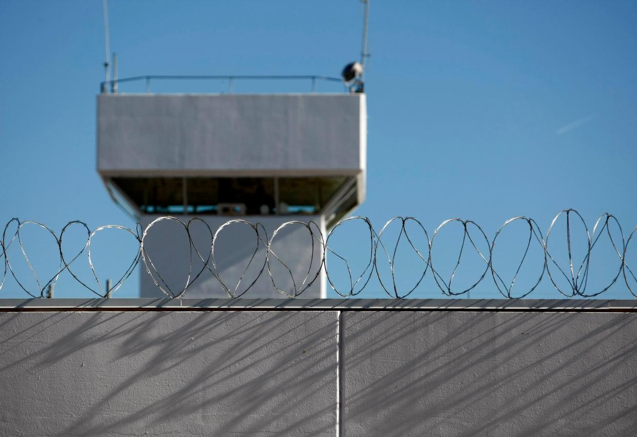 Razor wire tops a wall at the Dick Conner Correctional Center in Hominy in this 2014 file photo.