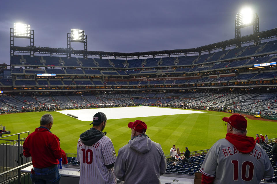 Fans arrive for Game 3 of baseball's World Series between the Houston Astros and the Philadelphia Phillies on Monday, Oct. 31, 2022, in Philadelphia. The game was postponed by rain Monday night with the matchup tied 1-1. (AP Photo/Matt Rourke)