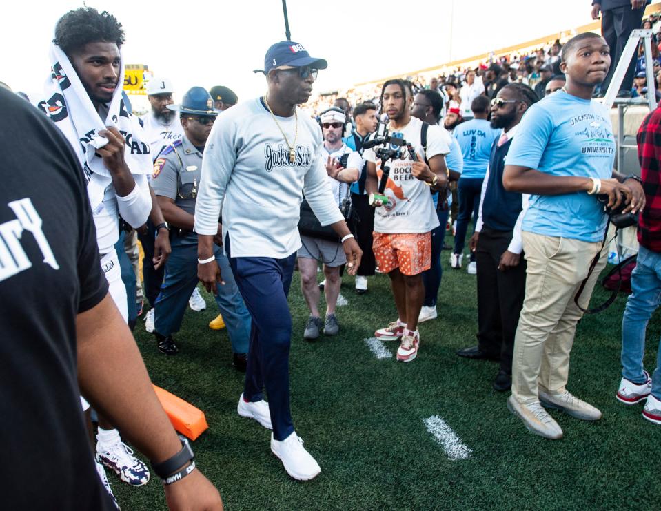 Jackson State Tigers head coach Deion Sanders and his son, quarterback Shedeur Sanders (2), walk off the field together as Alabama State Hornets takes on Jackson State Tigers at ASU Stadium in Montgomery, Ala., on Saturday, Oct. 8, 2022. Jackson State Tigers defeated Alabama State Hornets 26-12.