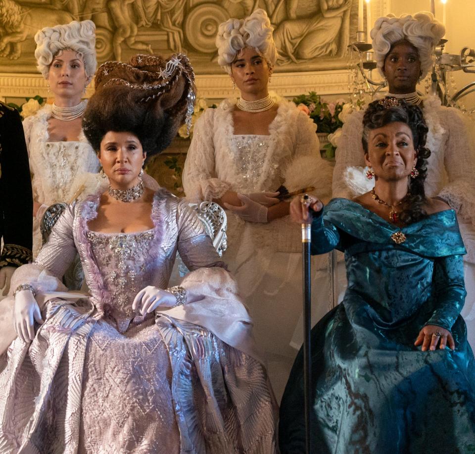 Queen Charlotte and Lady Agatha Danbury in extravagant gowns and elegant wigs