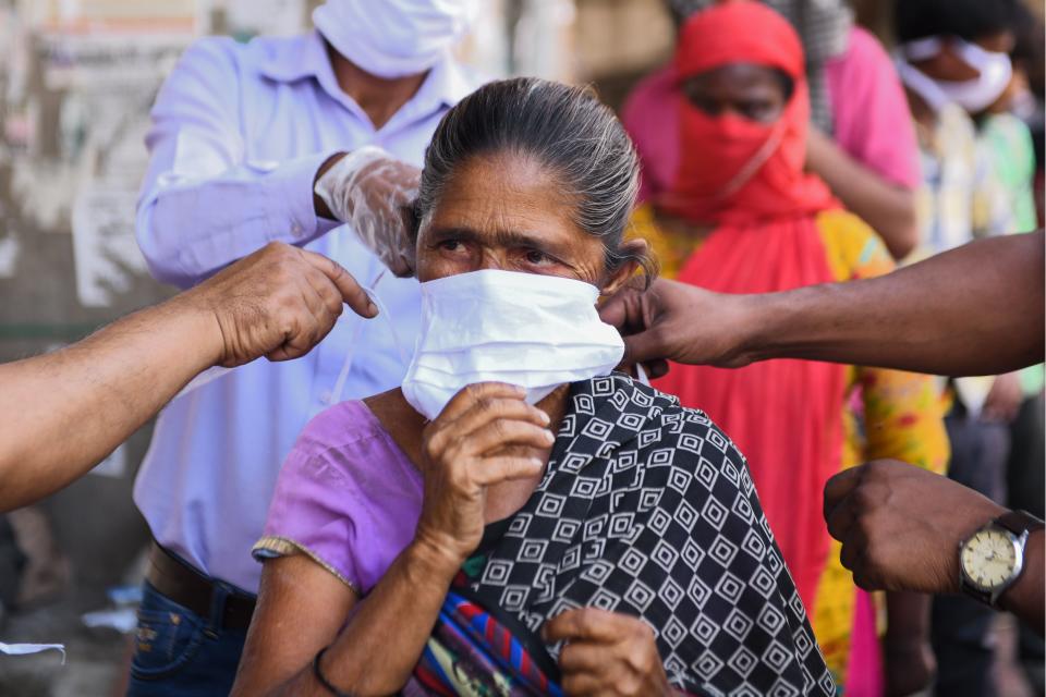 Volunteers of the Diocese of Amritsar Church of North India distribute facemasks to people during a government-imposed nationwide lockdown as a preventive measure against the COVID-19 coronavirus, in Amritsar on April 15, 2020. (Photo by NARINDER NANU / AFP) (Photo by NARINDER NANU/AFP via Getty Images)