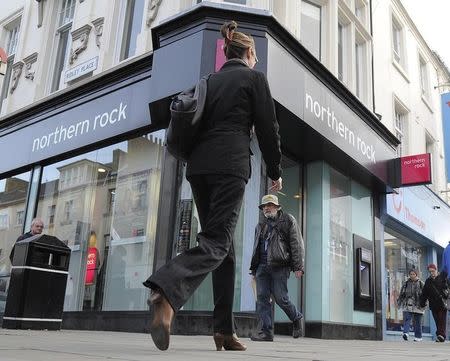 A woman passes a branch of Northern Rock bank in Newcastle, northern England November 17, 2011. REUTERS/Nigel Roddis