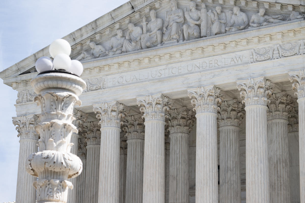 The front of the Supreme Court has a carved panel above the columns that reads: Equal justice under law.