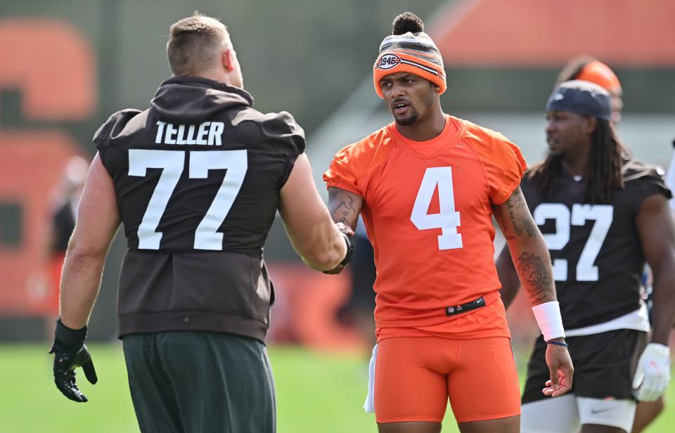 Browns quarterback Deshaun Watson (4) greets tackle Wyatt Teller (77) during organized team activities in Berea, May 25, 2022.