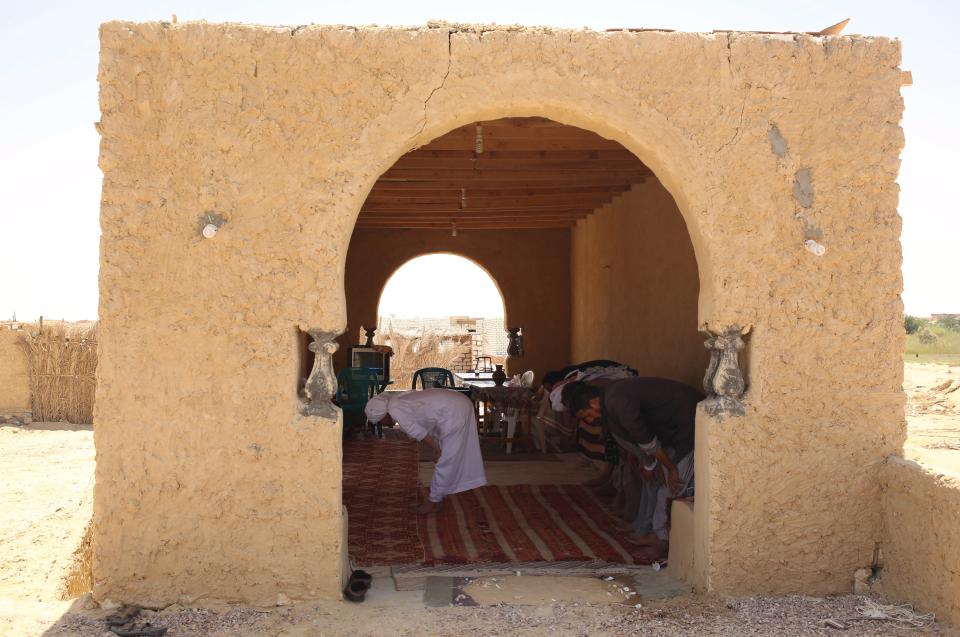 Patients pray at a rest area near Dakrour mountain prior to their sand bath in Siwa, Egypt, August 13, 2015. (REUTERS/Asmaa Waguih)