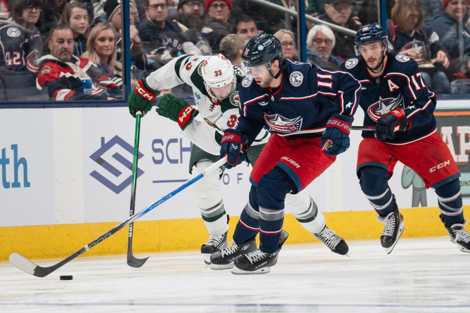 Jan 6, 2024; Columbus, Ohio, USA;
Columbus Blue Jackets center Adam Fantilli (11) races towards the puck against Minnesota Wild defenseman Alex Goligoski (33) during the third period of their game on Saturday, Jan. 6, 2024 at Nationwide Arena.