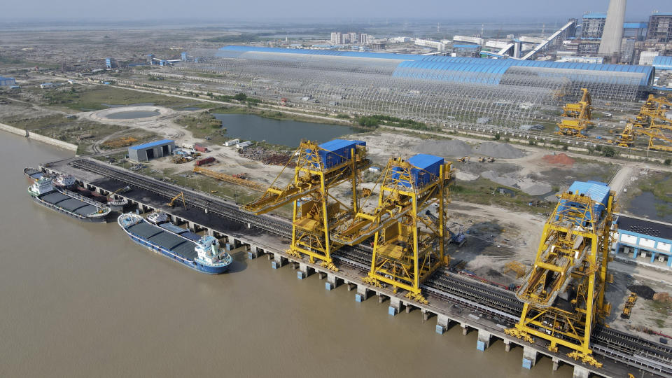 Ships with coal dock at the Maitree Super Thermal Power Project near the Sundarbans, the world’s largest mangrove forest, in Rampal, Bangladesh, Wednesday, Oct. 19, 2022. A power plant will start burning coal as part of Bangladesh’s plan to meet its energy needs and improve living standards, officials say. (AP Photo/ Al-emrun Garjon)