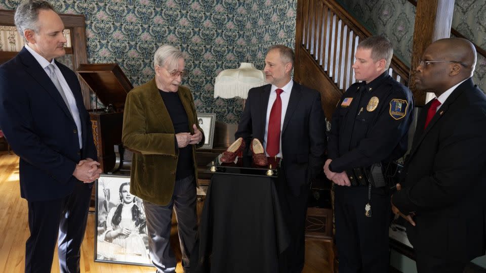 Michael Shaw, second from the left, is pictured being reunited with the slippers he owned for the first time since they were stolen in 2005. FBI agents discovered the shoes in a 2018 sting operation and sent them to the Smithsonian to confirm their authenticity. - FBI Minneapolis