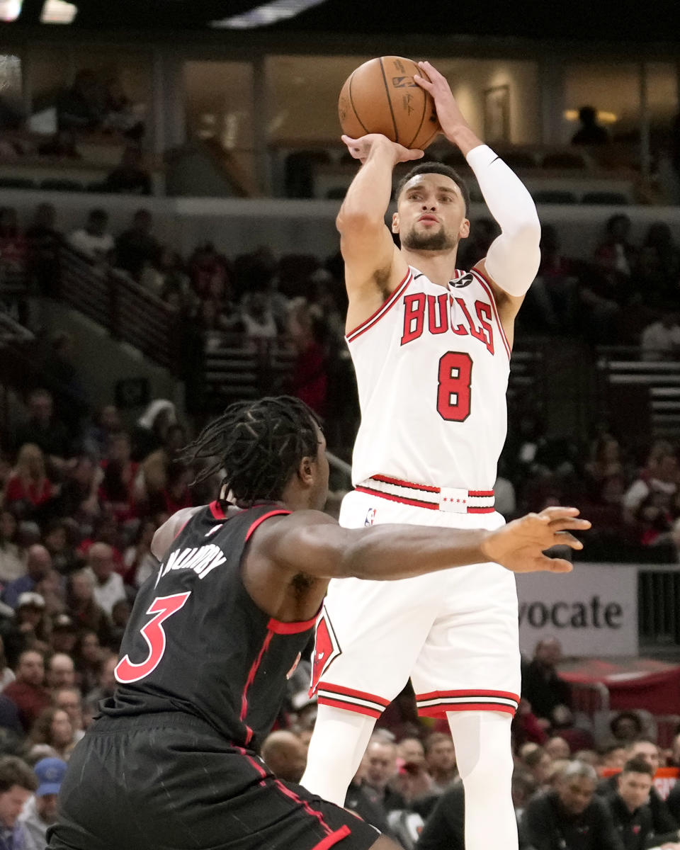 Chicago Bulls' Zach LaVine (8) shoots over Toronto Raptors' O.G. Anunoby (3) during the first half of an NBA basketball game Friday, Oct. 27, 2023, in Chicago. (AP Photo/Charles Rex Arbogast)