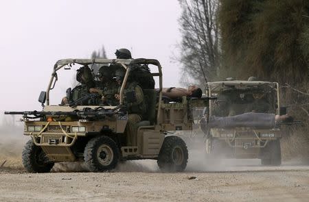 Israeli soldiers, wounded during an offensive in Gaza, are evacuated near the border with central Gaza Strip July 23, 2014. REUTERS/Yossi Aloni