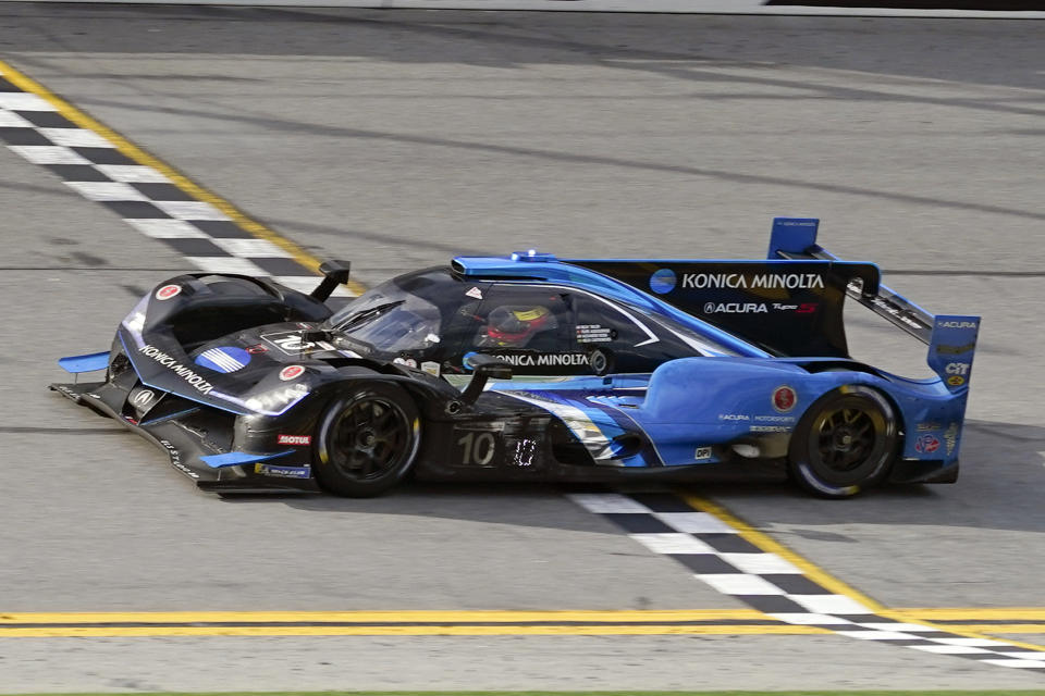 Filipe Albuquerque crosses the finish line in his Acura DPi to win the Rolex 24 hour auto race at Daytona International Speedway, Sunday, Jan. 31, 2021, in Daytona Beach, Fla. (AP Photo/John Raoux)