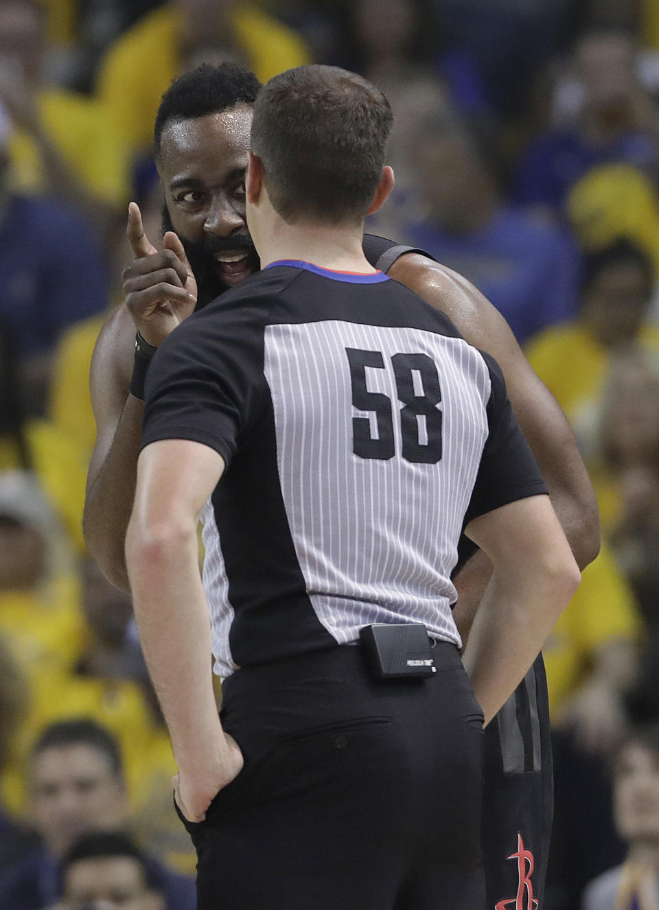 Houston Rockets guard James Harden, rear, talks to referee Josh Tiven during the first half of Game 1 of a second-round NBA basketball playoff series between the Golden State Warriors and the Rockets in Oakland, Calif., Sunday, April 28, 2019. (AP Photo/Jeff Chiu)