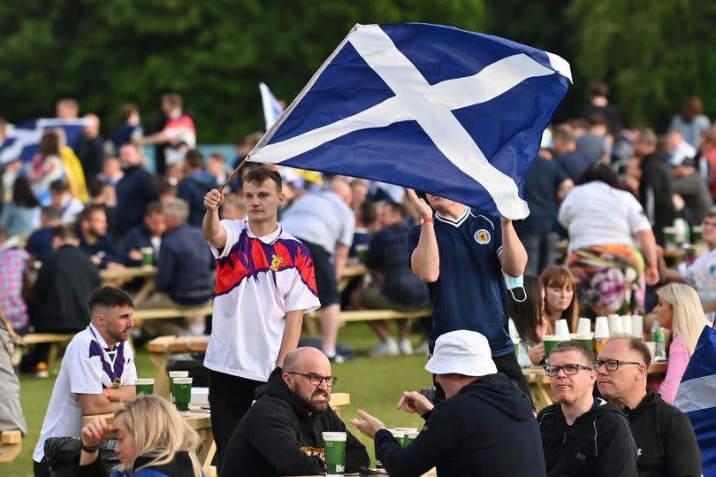 Scotland supporter flies a Saltire at the Fan Zone in Glasgow watching the UEFA EURO 2020 football match between England and Scotland being played in London on June 18, 2021.