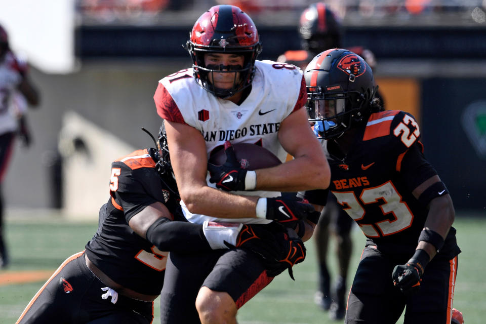 Oregon State linebacker Easton Mascarenas-Arnold (5) and defensive back Jermod McCoy (23) tackle San Diego State tight end Mark Redman (81) during the second half of an NCAA college football game Saturday, Sept. 16, 2023, in Corvallis, Ore. (AP Photo/Mark Ylen)
