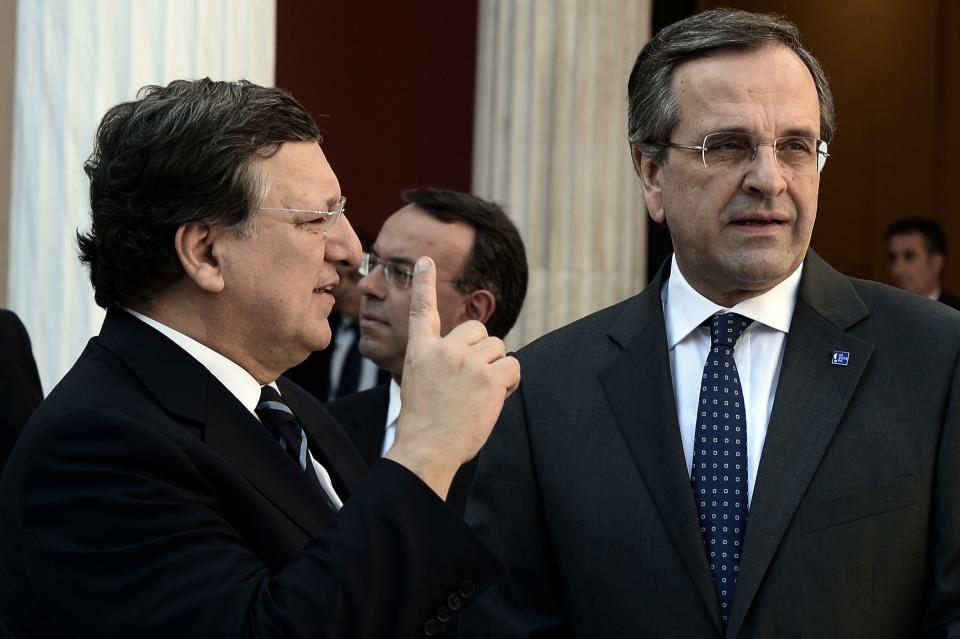 Greek Prime Minister Antonis Samaras, right, listens to European Commission President Jose Manuel Barroso during the take over ceremony of the six-month rotation of the Greek EU Presidency at Zappeion Hall in Athens, on Wednesday, Jan. 8, 2014. (AP Photo/Aris Messinis, Pool)