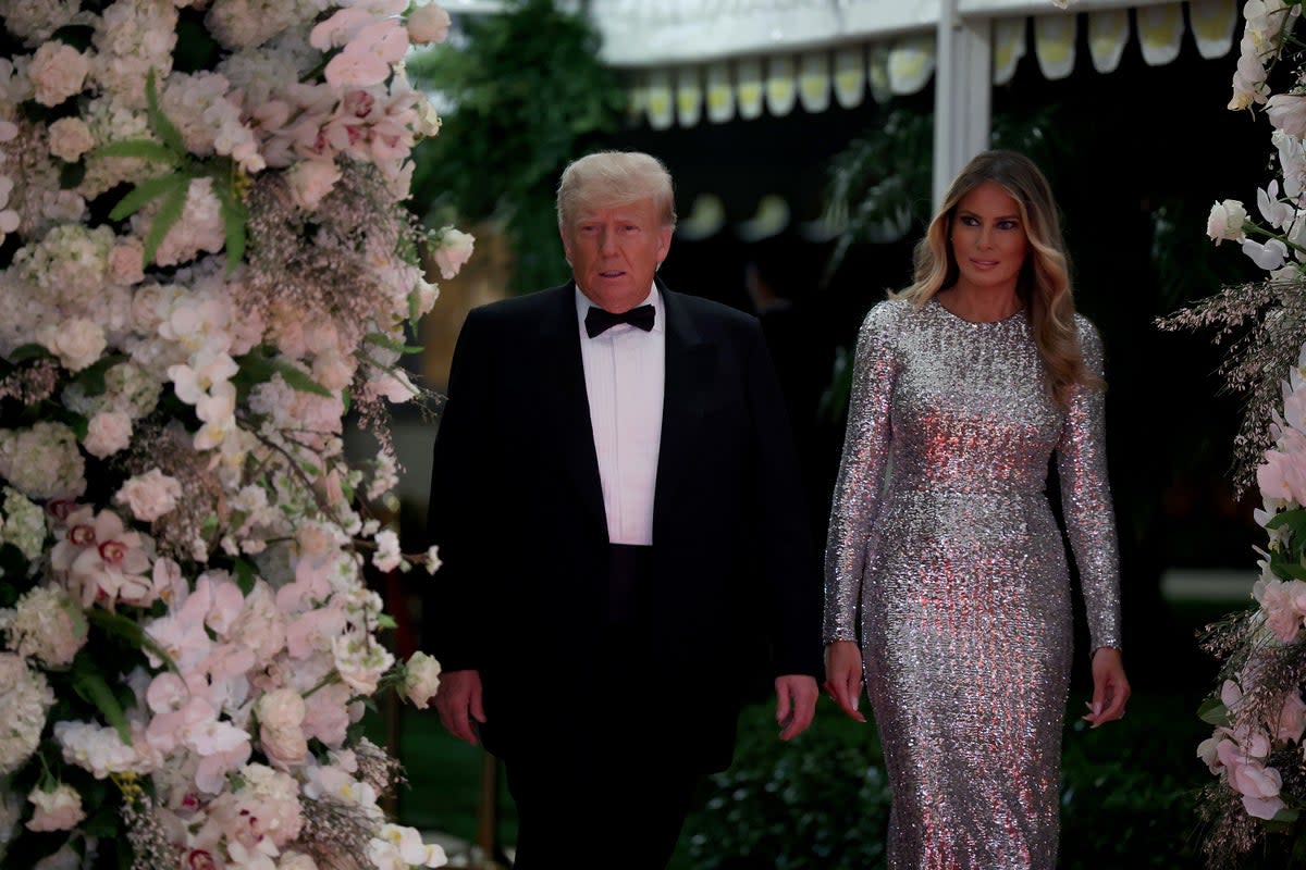 Former US president Donald Trump and former first lady Melania Trump arrive for a New Years event at his Mar-a-Lago home on 31 December 2022 (Getty Images)