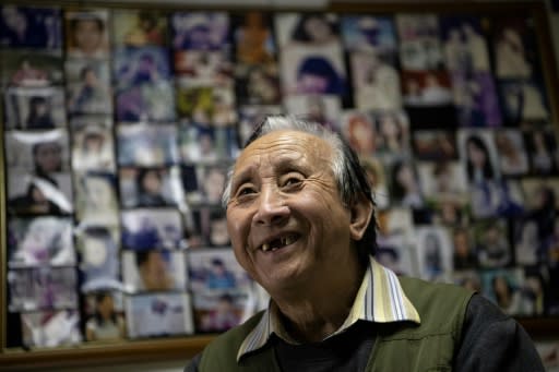 Beijing Matchmaker Zhu Fang's walls are covered with headshots of hopeful singles looking for love