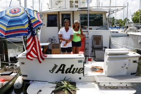 Marvin and Marilyn Foster, who live in a ship and plan to stay aboard during Hurricane Dorian, pose for a photo at a marina in Merritt Island