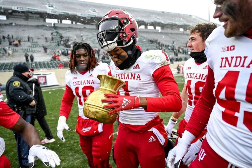 Indiana's Donaven McCulley celebrates with the Old Brass Spittoon trophy after beating Michigan State on Saturday, Nov. 19, 2022, at Spartan Stadium in East Lansing.

221119 Msu Indiana 203a