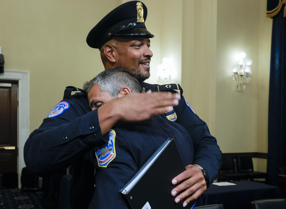 U.S. Capitol Police Sgt. Harry Dunn hugs Washington Metropolitan Police Department officer Michael Fanone after a House select committee hearing on the Jan. 6 attack on Capitol Hill in Washington, Tuesday, July 27, 2021. (Jim Bourg/Pool via AP)