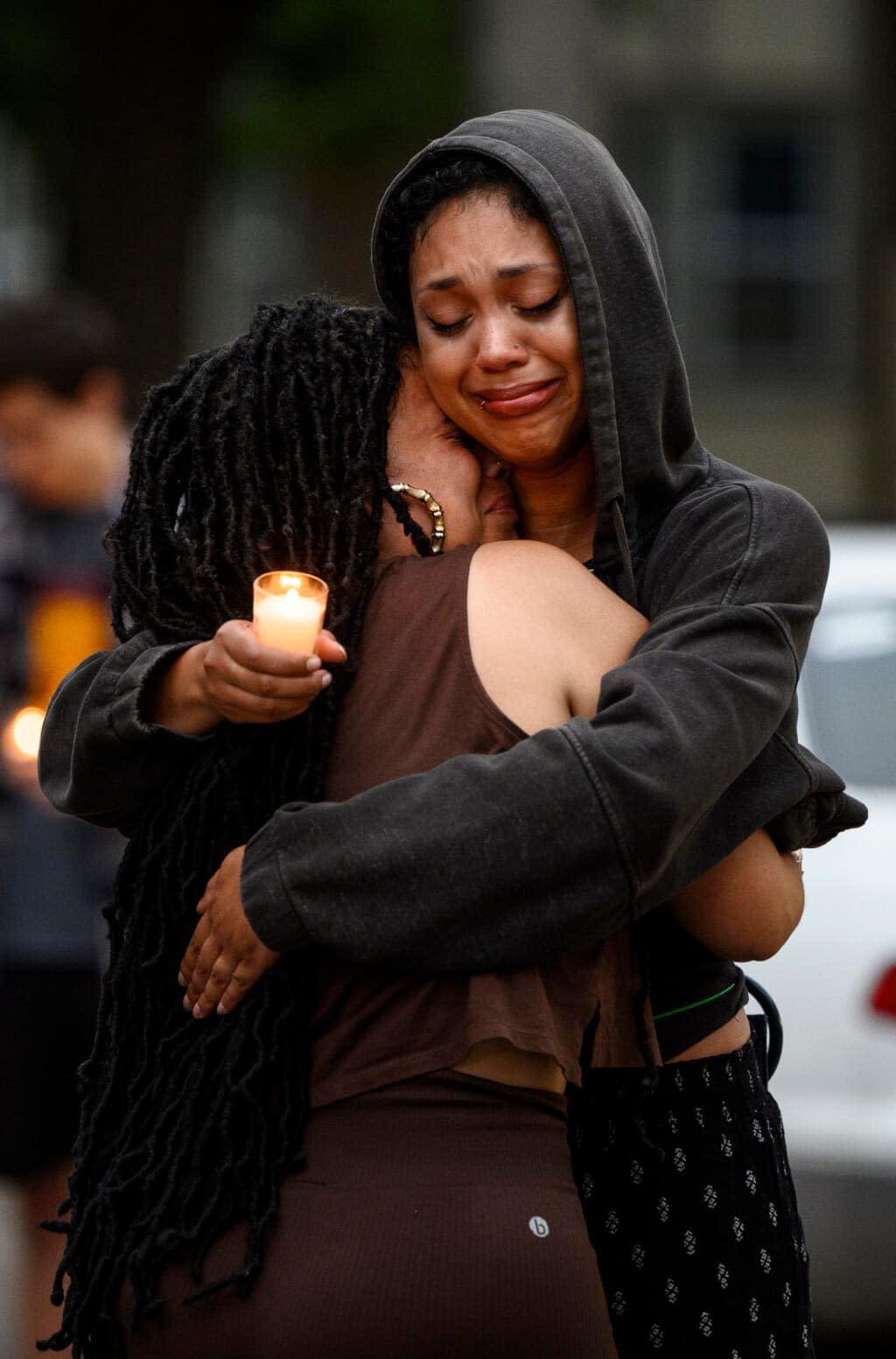 Two mourners who were close to the family, and who didn’t wish to be identified, embrace during a vigil for 20-year old Andrew Tekle Sundberg Thursday, July 14, 2022 outside the apartment building where he was killed by Minneapolis Police in Minneapolis. (Aaron Lavinsky/Star Tribune via AP)