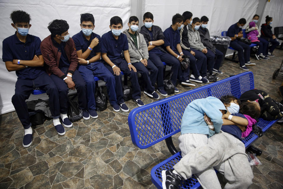 FILE - In this March 30, 2021, file photo, young unaccompanied migrants wait for their turn at the secondary processing station inside the U.S. Customs and Border Protection facility, the main detention center for unaccompanied children in the Rio Grande Valley, in Donna, Texas. U.S. authorities say they picked up nearly 19,000 children traveling alone across the Mexican border in March. It's the largest monthly number ever recorded and a major test for President Joe Biden as he reverses many of his predecessor's hardline immigration tactics. (AP Photo/Dario Lopez-Mills, Pool, File)