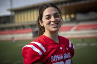 Simon Fraser University football team kicker Kristie Elliott poses for a photograph before practice at the university in Burnaby, B.C., Tuesday, Sept. 21, 2021. Elliott is a 21-year-old pschyhology major who runs track and played soccer. She says it was an adjustment to play football but she loves it. (Darryl Dyck/The Canadian Press via AP)