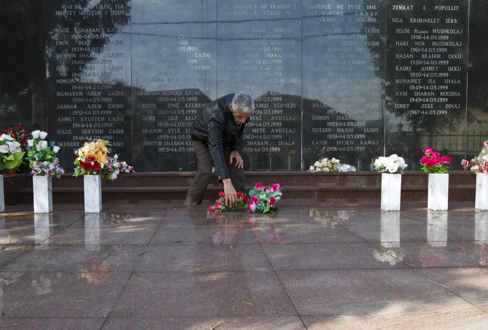 Rexhe Kelmendi, one of three survivors of the Cuska massacre, pays his respect as he visits the Martyr's cemetery in the village of Cuska, Kosovo on Tuesday, Feb. 11, 2014. Serbia's war crimes court on Tuesday convicted nine former paramilitaries of the brutal killings of more than 100 ethnic Albanian civilians during the Kosovo war and sentenced them to between two and 20 years in prison. The crime by the "Jackals" paramilitary group includes the massacre of 41 people in the Kosovo village of Cuska where Serbs rounded up villagers, robbed them, separated women and children from men, locked the men in a house and set it on fire. The brutality of Serbia's crackdown prompted NATO to intervene with airstrikes to stop the war. (AP Photo/Visar Kryeziu)