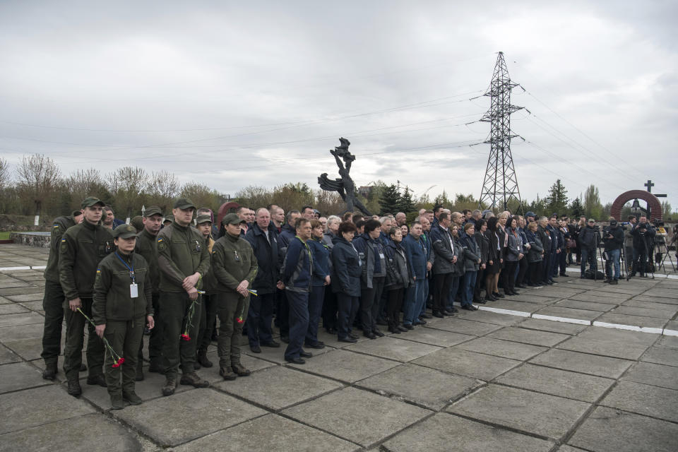 Chernobyl's nuclear power plant workers attend a memorial ceremony for the victims of the Chernobyl tragedy in Chernobyl, Ukraine, Wednesday, April 26, 2023. Ukrainian President Volodymyr Zelenskyy on Wednesday used the 37th anniversary of the world’s worst nuclear disaster to repeat his warnings about the potential threat of a new atomic catastrophe in Ukraine amid his country's war with Russia. (AP Photo/Wladyslaw Musiienko)