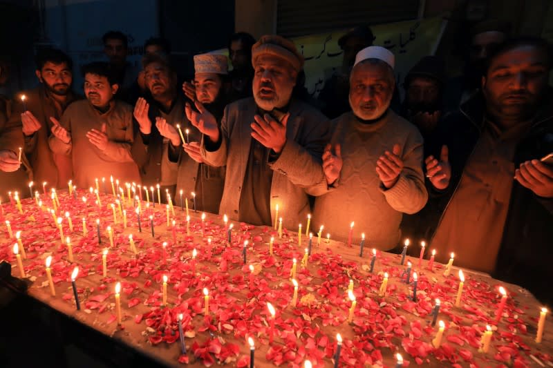 People pray and light candles for the victims, who were killed during heavy snowfall and avalanches in Neelum Valley, in Peshawar