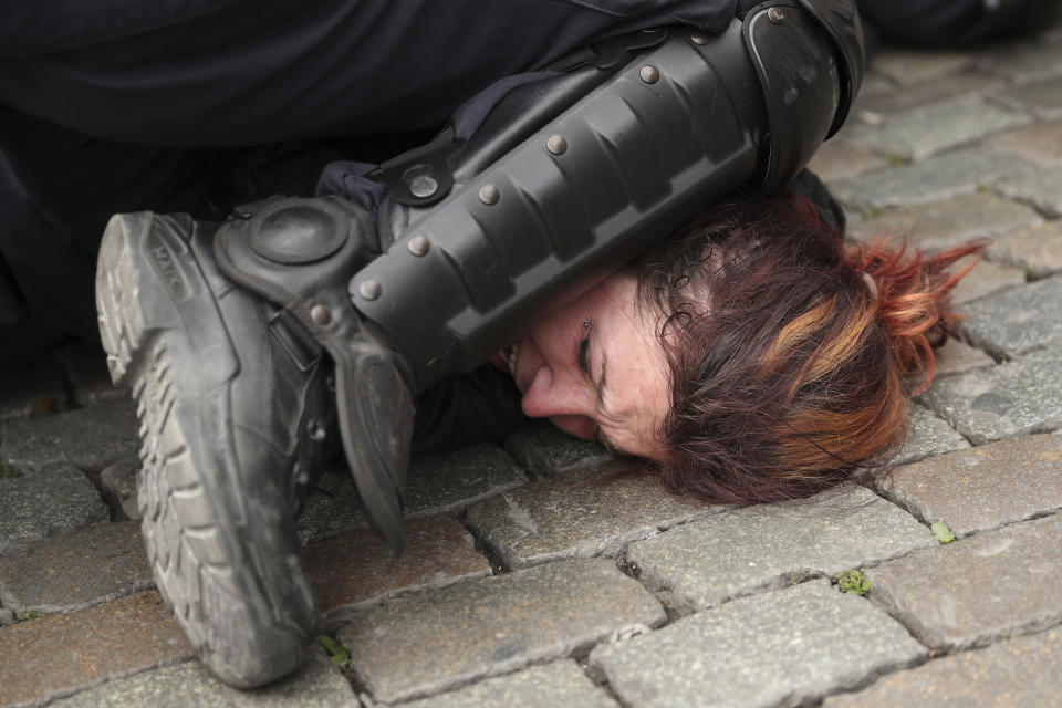 Police detain a woman during a yellow vest protest with other groups in Brussels, Sunday, May 26, 2019. The demonstration took place as Belgium took to the polls to elect regional, national and European candidates. (AP Photo/Francisco Seco)