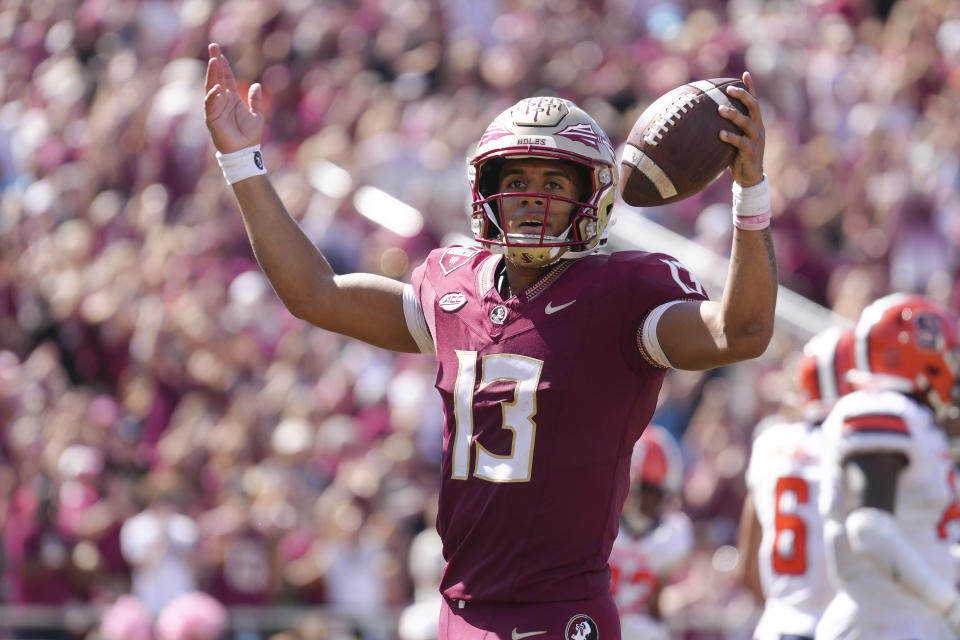 TALLAHASSEE, FL - OCTOBER 14: Florida State Seminoles quarterback Jordan Travis (13) celebrates after breaking the school touchdown record with this touchdown in the second half during the game between the Syracuse Orange and the Florida State Seminoles on Saturday, October 14, 2023 at Bobby Bowden Field at Doak Campbell Stadium, Tallahassee, Fla. (Photo by Peter Joneleit/Icon Sportswire via Getty Images)
