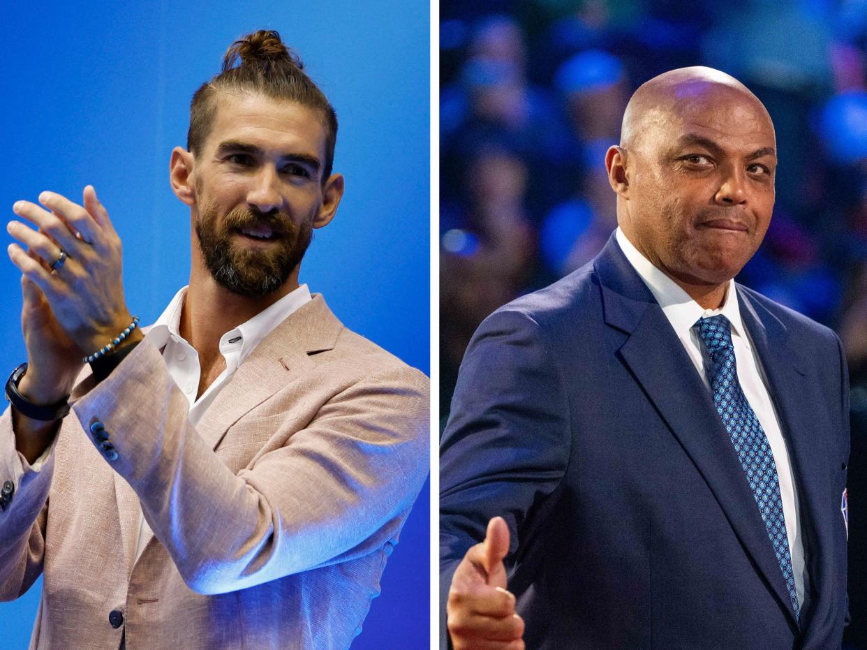 Michael Phelps (left) claps; Charles Barkley gives a thumbs up.