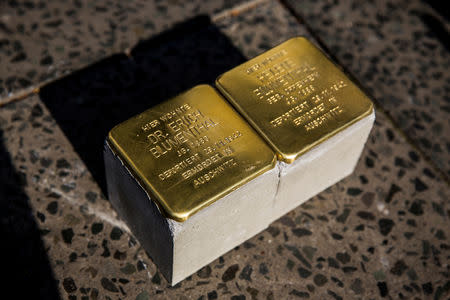 FILE PHOTO: Two pieces of the Holocaust memorial project "Stolpersteine" (stumbling blocks) are seen before being installed into the pavement outside a residential building in Berlin, April 25, 2014. Today there are 45,000 "Stolpersteine" in Germany and 16 other European countries. REUTERS/Thomas Peter/File Photo