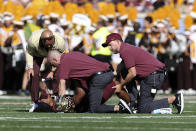 Minnesota wide receiver Chris Autman-Bell is checked on by athletic trainers and head coach P.J. Fleck after a lower leg injury during the first half of an NCAA college football game against Colorado, Saturday, Sept. 17, 2022, in Minneapolis. (AP Photo/Stacy Bengs)