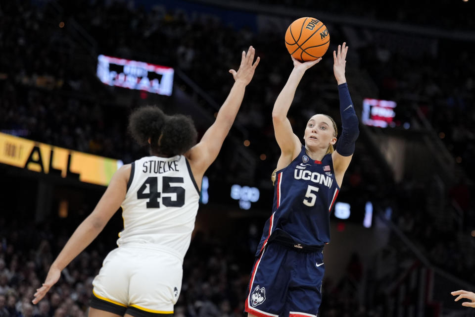 UConn guard Paige Bueckers (5) shoots over Iowa forward Hannah Stuelke (45) during the first half of a Final Four college basketball game in the women's NCAA Tournament, Friday, April 5, 2024, in Cleveland. (AP Photo/Morry Gash)