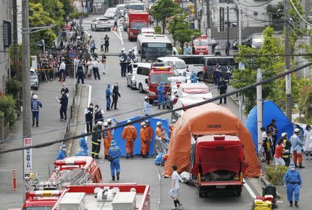 Rescue workers and police officers operate at the site where sixteen people were injured in a suspected stabbing by a man, in Kawasaki, Japan May 28, 2019. in this photo released by Kyodo. Mandatory credit Kyodo/via REUTERS